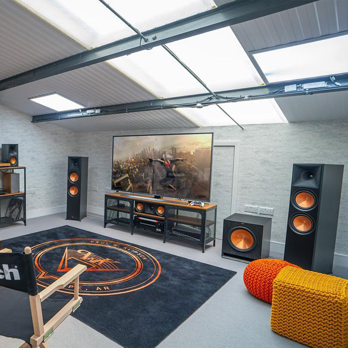 Bright game room with multiple speakers and vibrant seating, showcasing top game room ideas for the ultimate gaming cave setup. Bright game room with multiple speakers and vibrant seating, showcasing top game room ideas for the ultimate gaming cave setup.