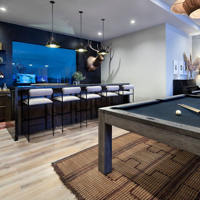 Bar and pool table in a bright game room 