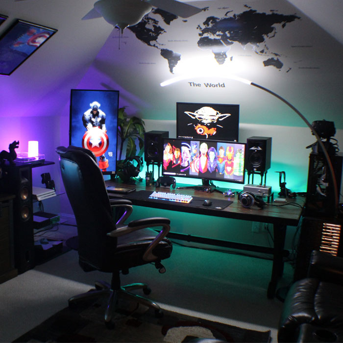 Dark attic game room with multiple monitors, colorful LED lighting, gaming chair, and wall map for immersive gaming cave ideas. Dark attic game room with multiple monitors, colorful LED lighting, gaming chair, and wall map for immersive gaming cave ideas.