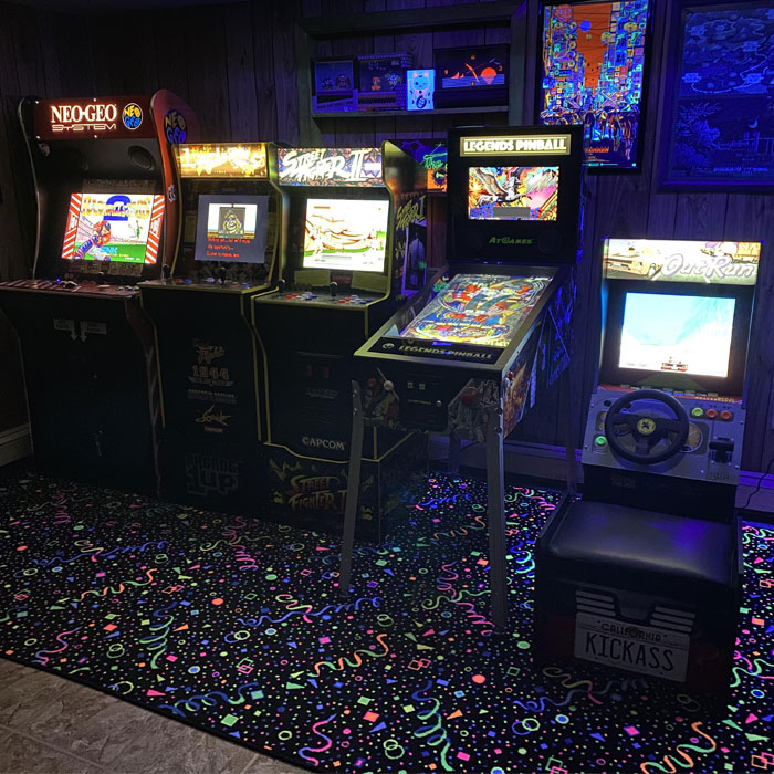Multiple vintage arcades in a dark game room