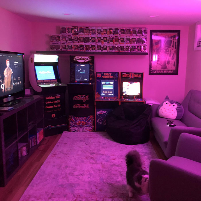 Basement game room with purple lighting, retro arcade machines, cozy seating, and collectibles for game room ideas. Basement game room with purple lighting, retro arcade machines, cozy seating, and collectibles for game room ideas.