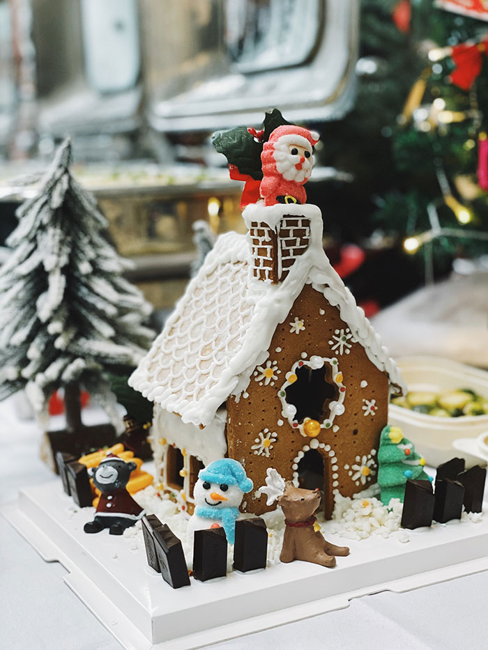 Gingerbread house with Santa Claus on the roof.