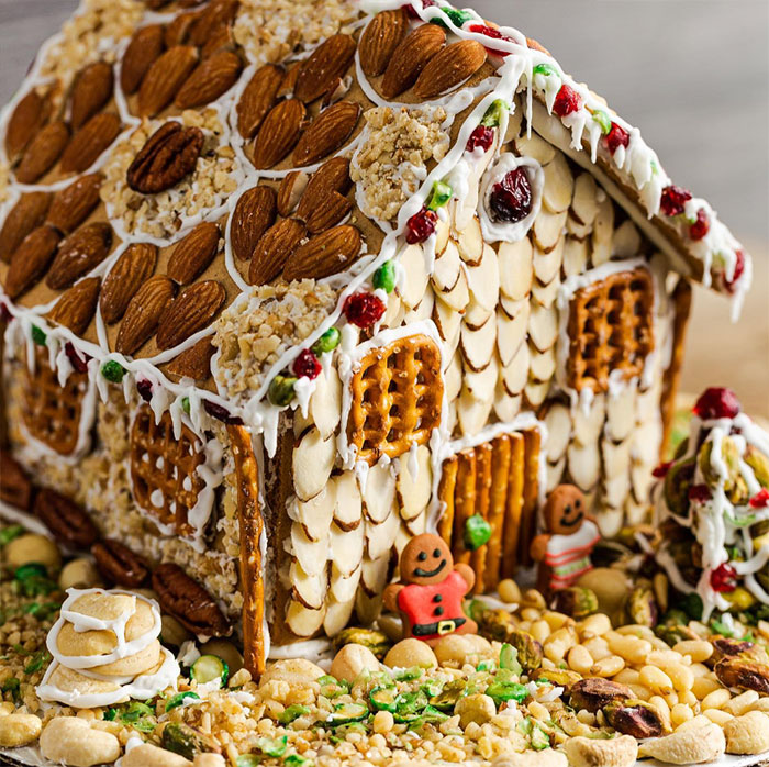 Gingerbread house covered with nuts.