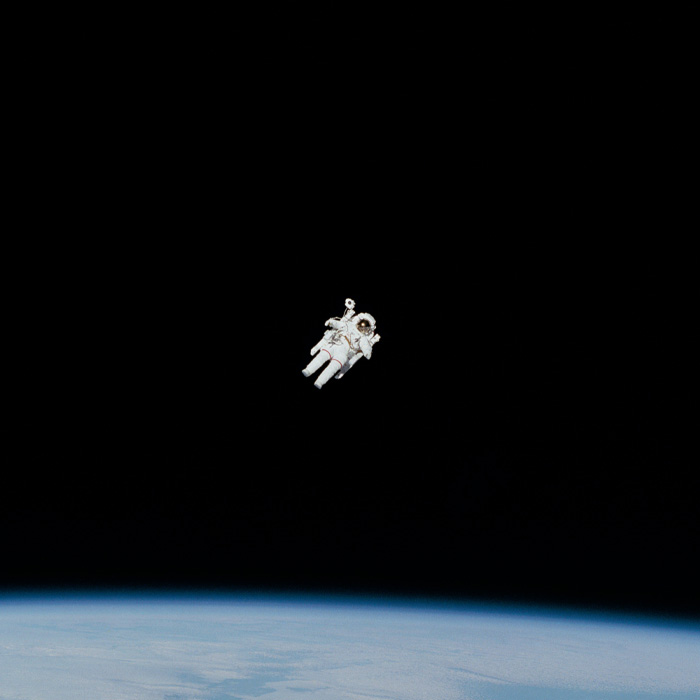 Astronaut in the spacesuit floating in the space 