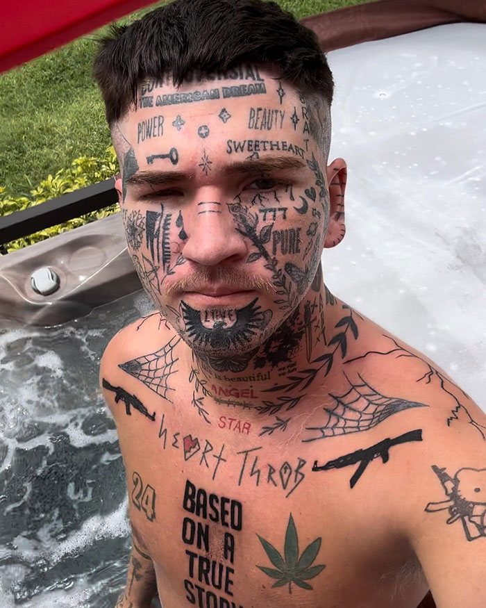 TikToker Ethan covered in various tattoos standing in a hot tub, trolling bullies with creative ink. TikToker Ethan covered in various tattoos standing in a hot tub, trolling bullies with creative ink.