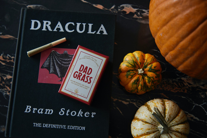 Dracula book and pumpkins near