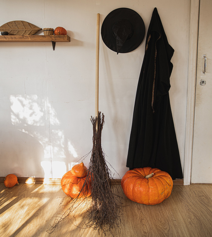 Broom, pumpkins and witch clothes