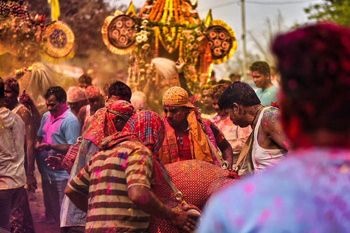 People celebrating covered in colored powder