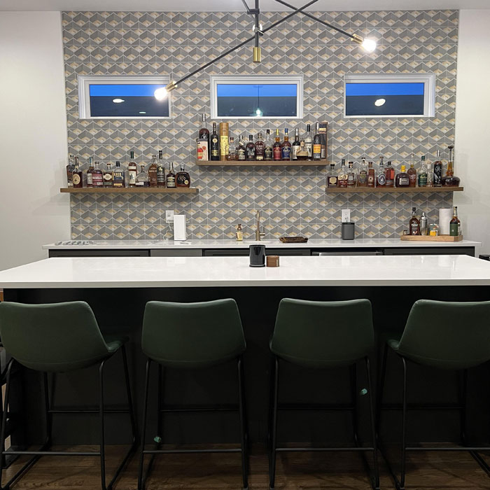 Aesthetic bright home bar with green chairs 