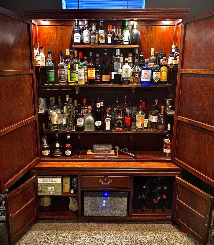 Old brown cabinet with bottles in it