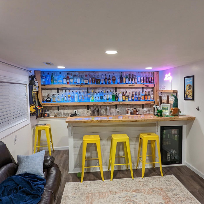 Spacious home bar with wooden flooring 