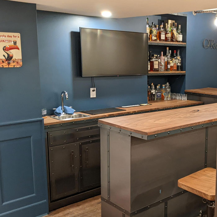 Small blue home bar with a sink 