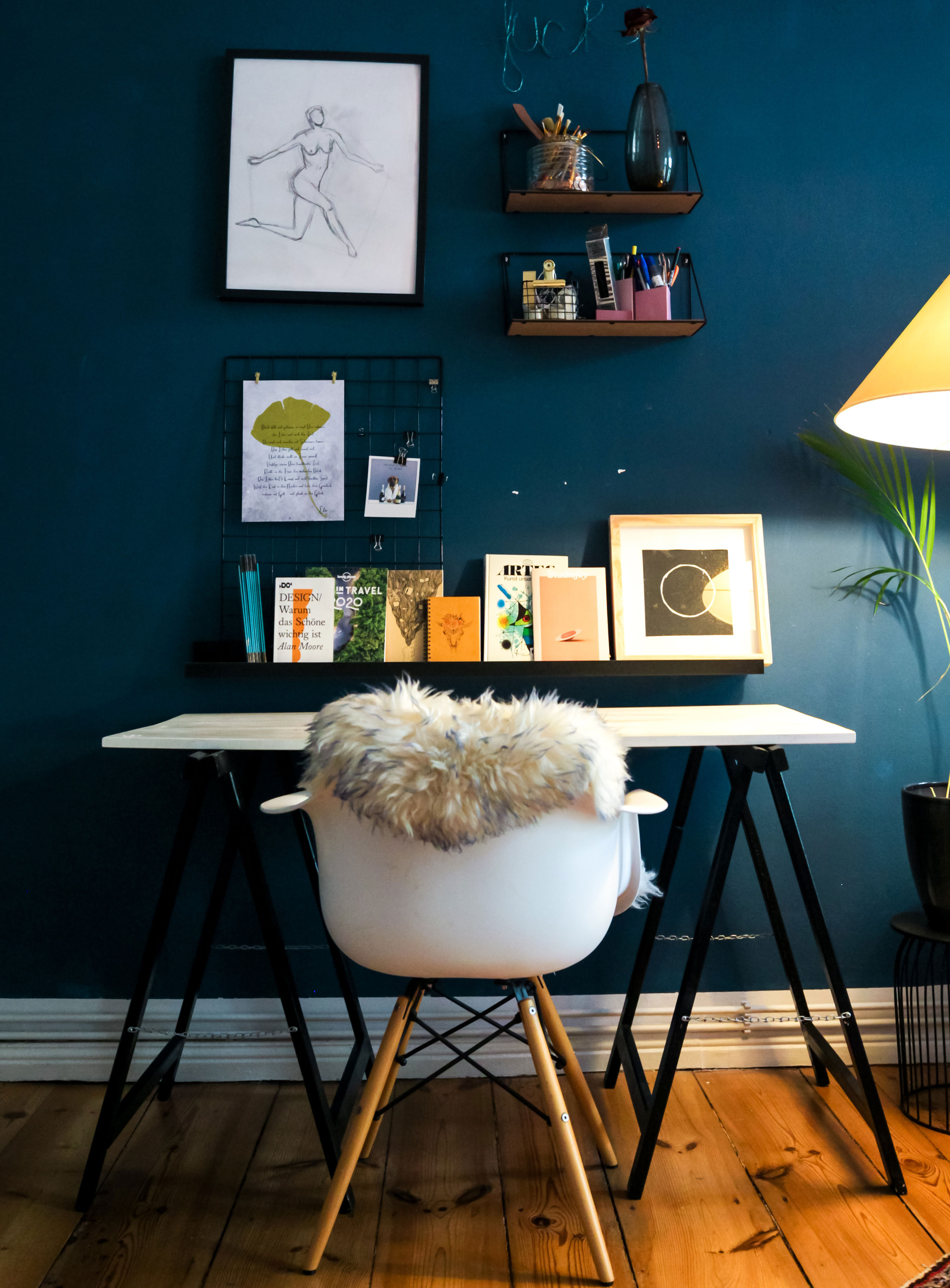 White fur textile draped over a chair in a stylish home office showcasing modern home office ideas. White fur textile draped over a chair in a stylish home office showcasing modern home office ideas.