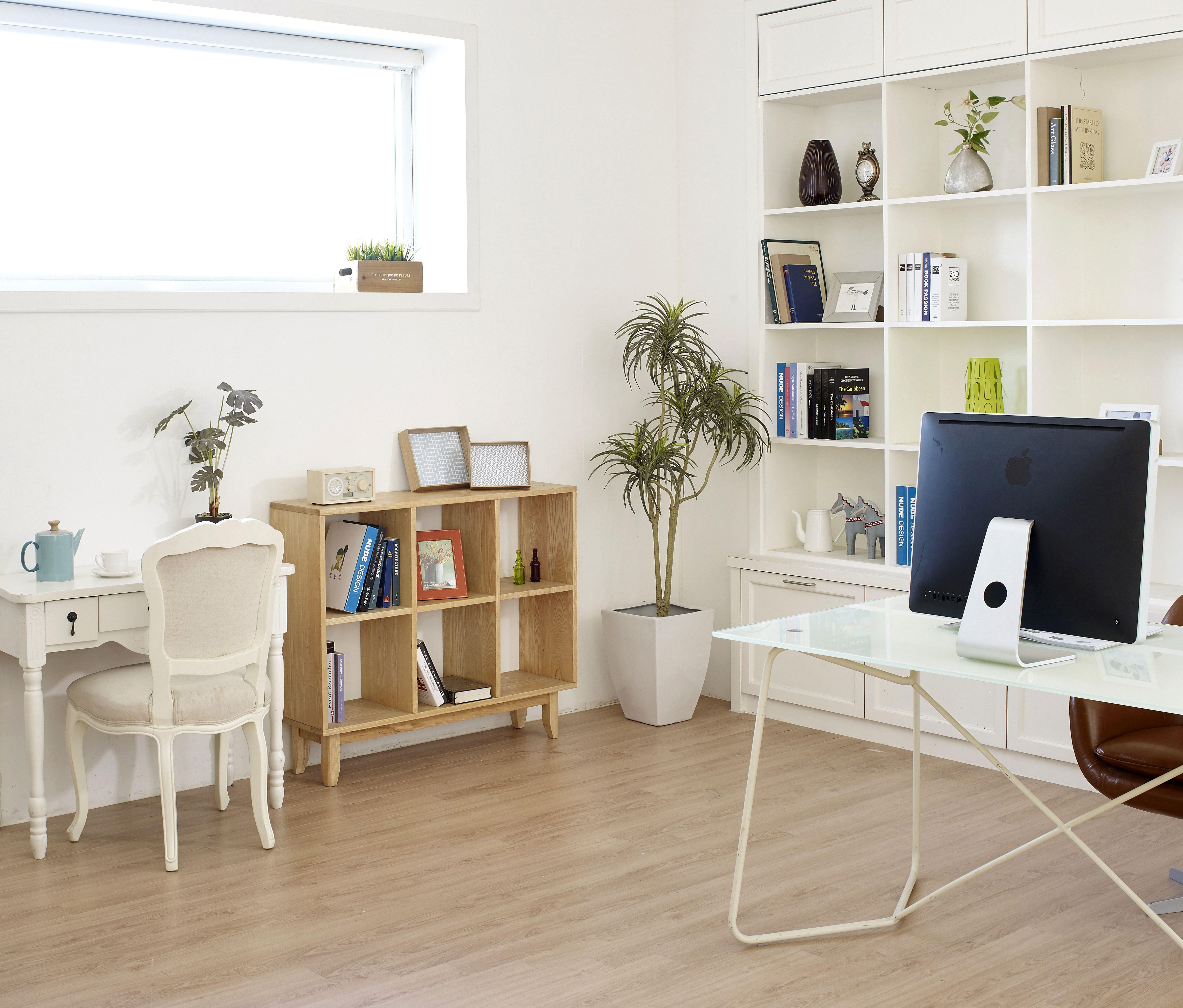 Bright home office with open shelves and modern desk setup for a productive work process and inspired ideas. Bright home office with open shelves and modern desk setup for a productive work process and inspired ideas.