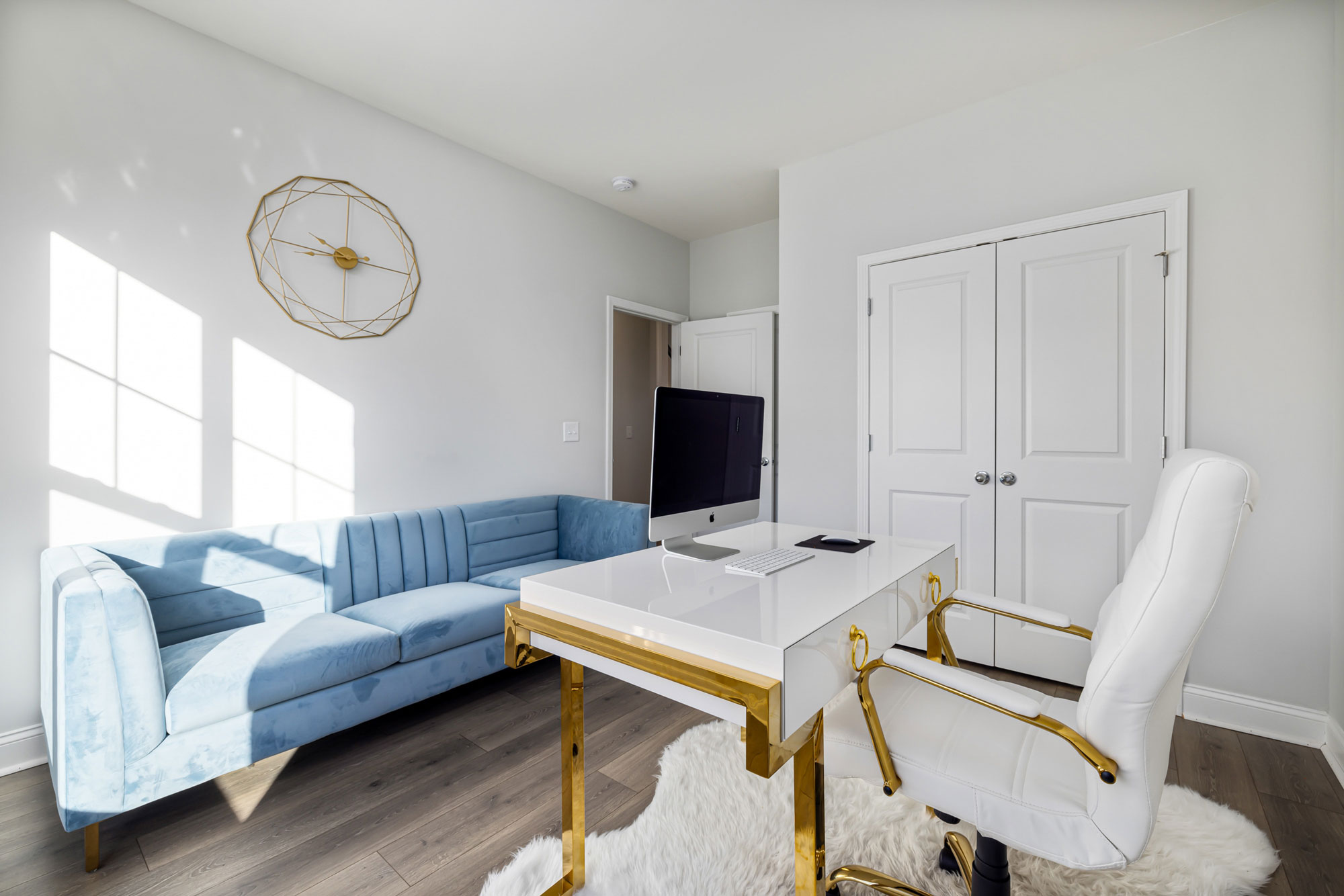 Modern home office setup with a white desk and chair featuring golden details for productive work ideas Modern home office setup with a white desk and chair featuring golden details for productive work ideas