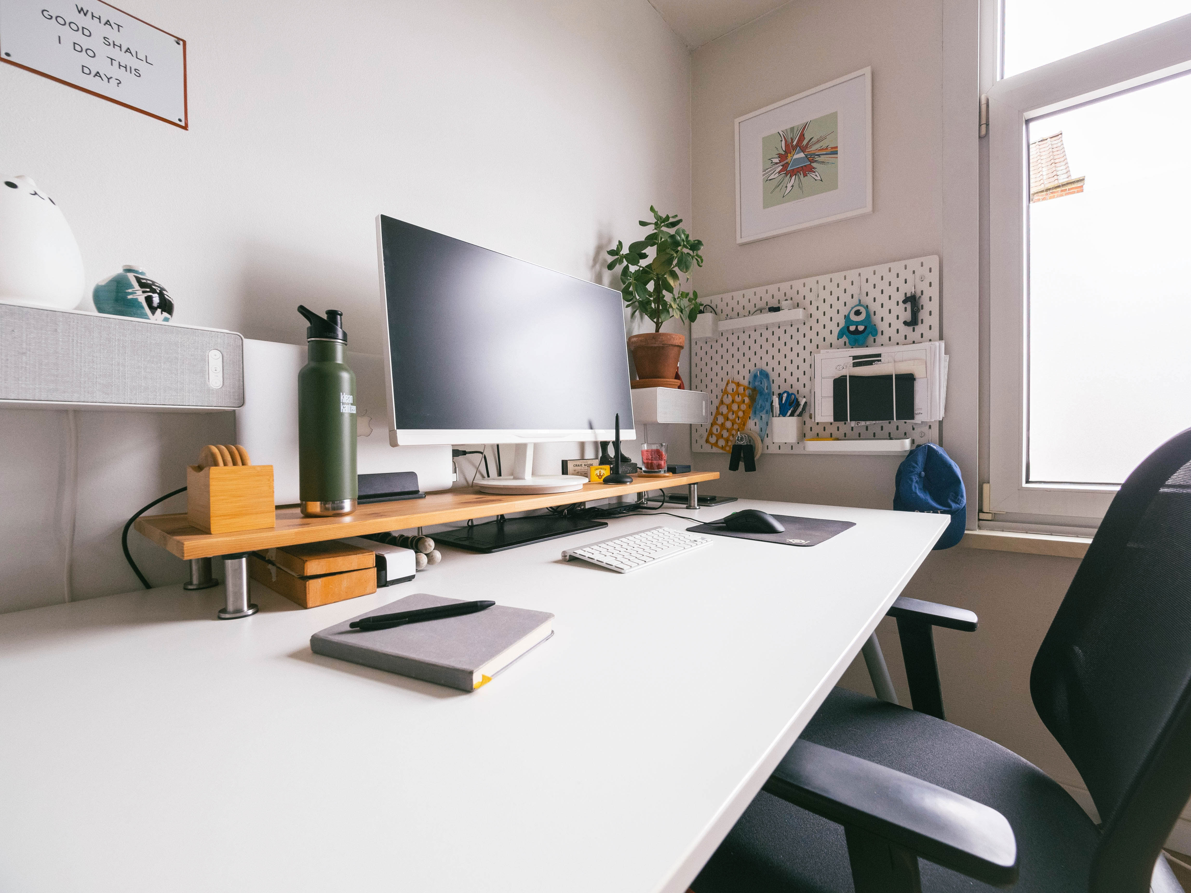 Modern home office setup with pegboard organization near table, computer monitor, and ergonomic chair for productive work environment Modern home office setup with pegboard organization near table, computer monitor, and ergonomic chair for productive work environment