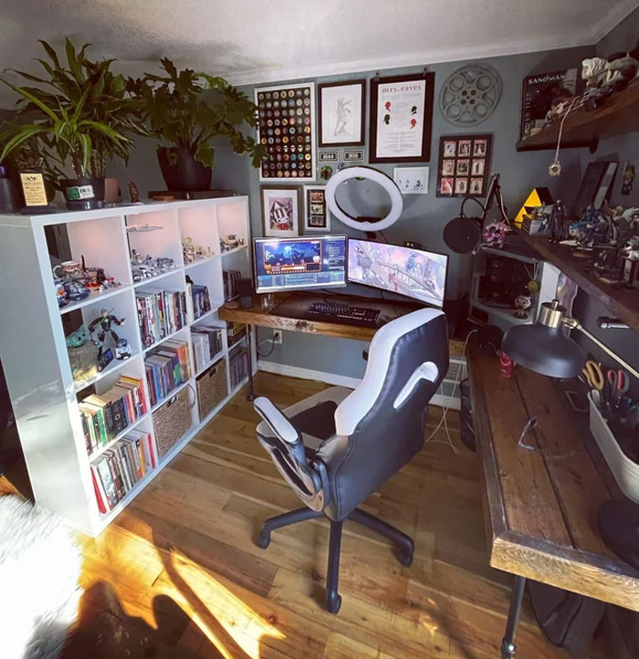 Home office with open shelves, dual monitors, wall pictures, and organized workspace for a productive work process. Home office with open shelves, dual monitors, wall pictures, and organized workspace for a productive work process.