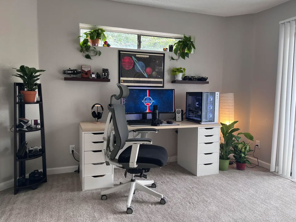 Modern home office setup with monitor, shelves, and plants creating an inspiring and productive workspace design. Modern home office setup with monitor, shelves, and plants creating an inspiring and productive workspace design.