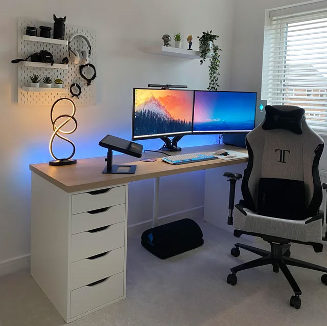 Wooden desk with dual monitors, modern LED lamp, ergonomic chair, and minimal decor for home office ideas. Wooden desk with dual monitors, modern LED lamp, ergonomic chair, and minimal decor for home office ideas.