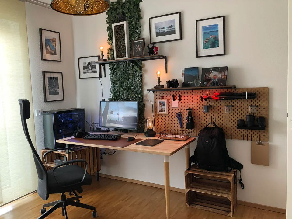 Desk near wall with pictures in frame