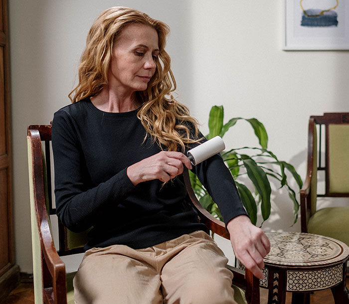 Woman Using Lint Remover Woman Using Lint Remover