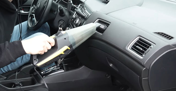 Person using vacuum cleaner in car Person using vacuum cleaner in car