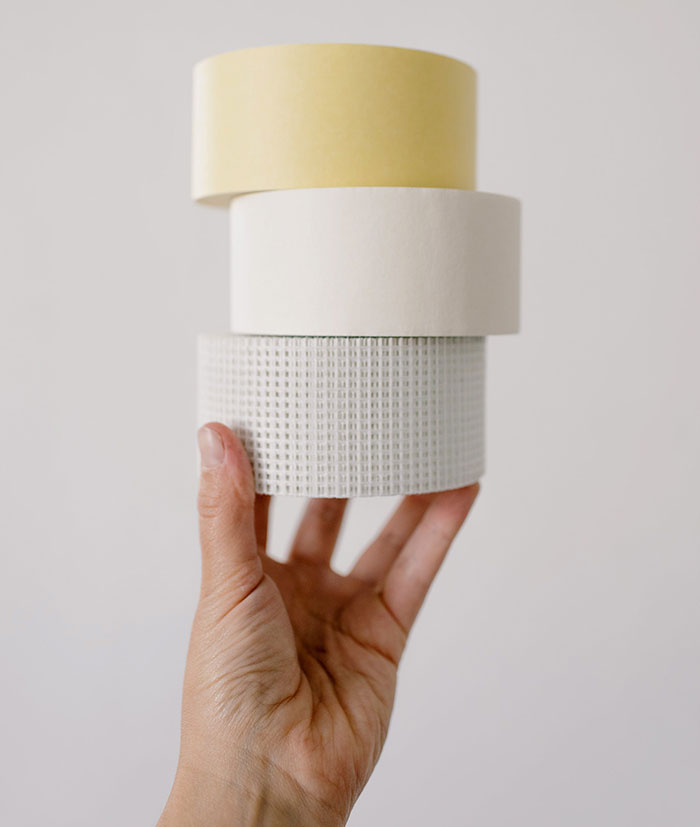 person holding masking tape in hand person holding masking tape in hand