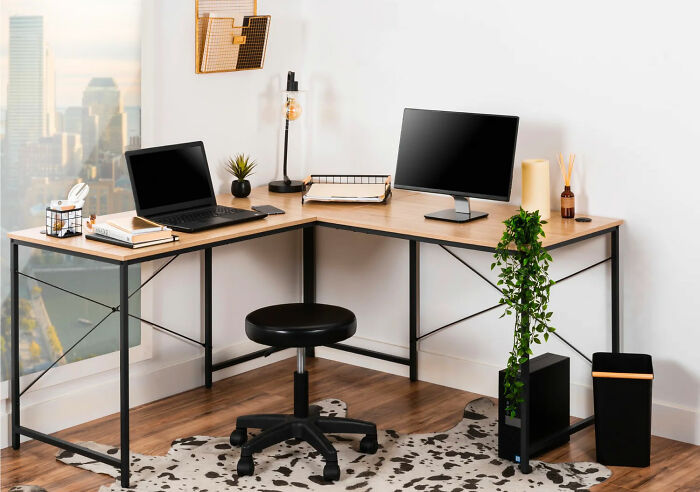 L-shaped office desk with computer and books