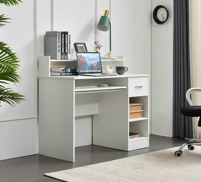 room with white wooden desk with storages