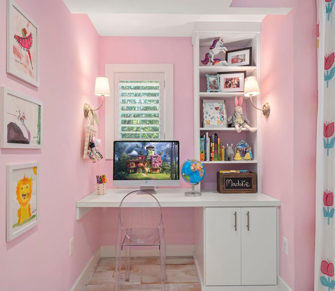 Pink room with white table and bookshelf