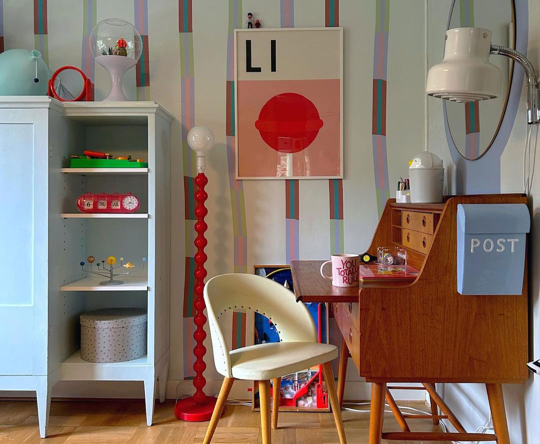 Colorful room with wooden desk white chair and blue bookshelf