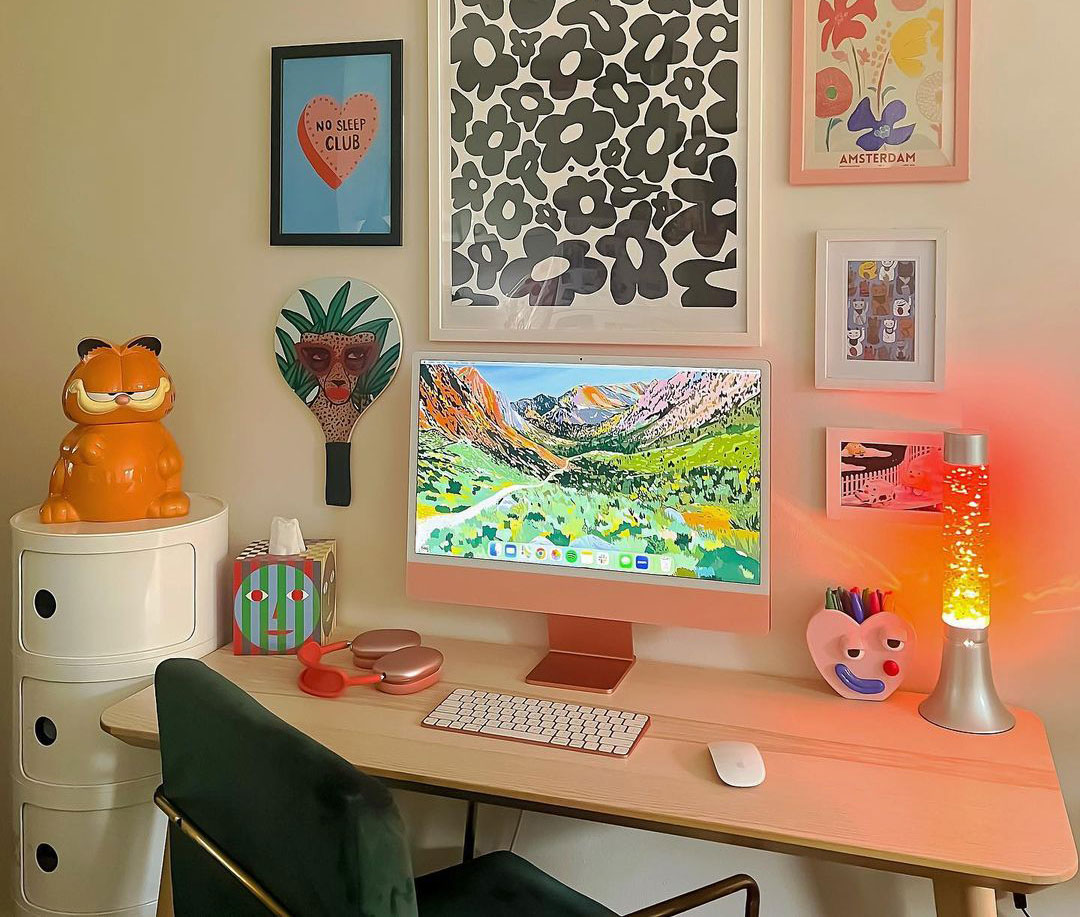 Colorful room wall with paintings and wooden desk