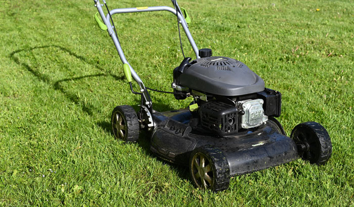 Black lawn mover on the grass Black lawn mover on the grass