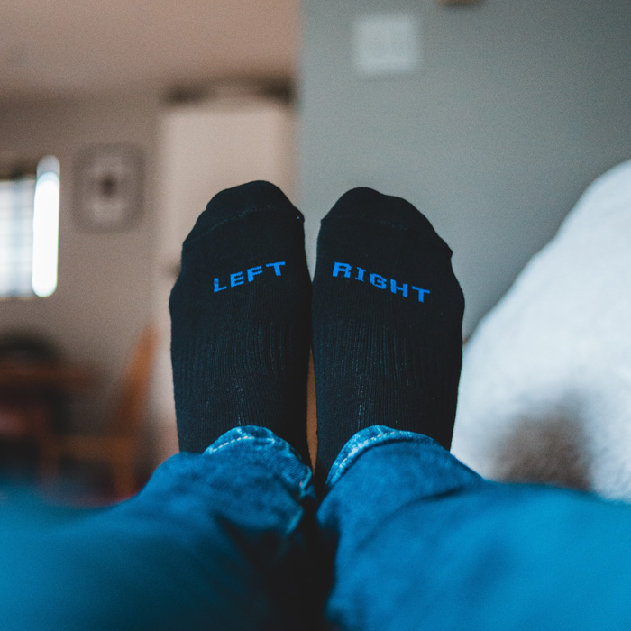Person in blue jeans and black socks 