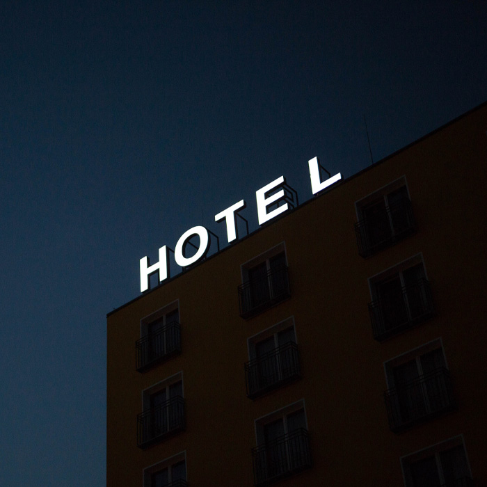 Hotel lighted signature on the top of a building 