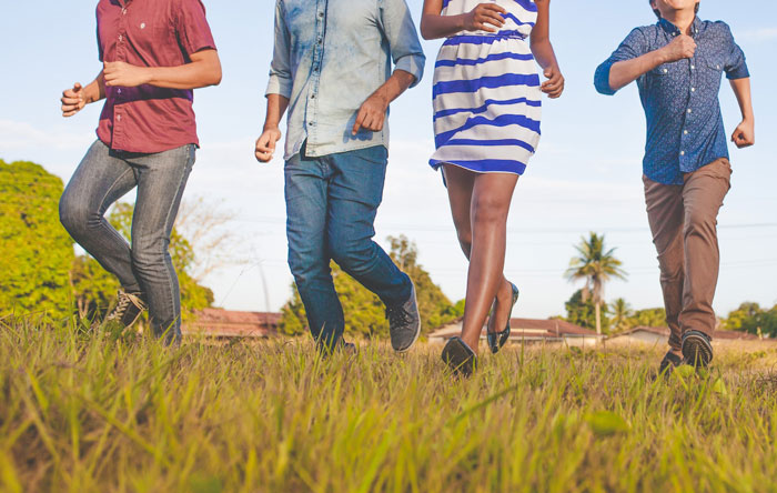 Family walking outside together on grass, representing a man visiting mom to introduce baby son amid family intervention Family walking outside together on grass, representing a man visiting mom to introduce baby son amid family intervention