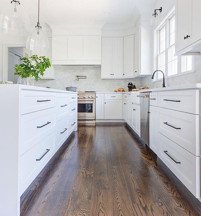 Bright white kitchen featuring Jacobean colored floor showcasing Minwax stain colors for wood stain choices. Bright white kitchen featuring Jacobean colored floor showcasing Minwax stain colors for wood stain choices.