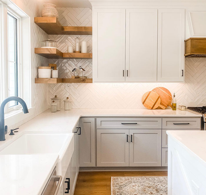 Bright bathroom kitchen featuring Weathered Oak wood stain colors on floating shelves and hood accents. Bright bathroom kitchen featuring Weathered Oak wood stain colors on floating shelves and hood accents.