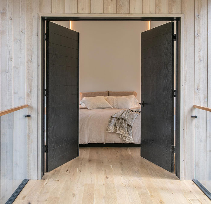 True black wood stained double doors leading to a cozy bedroom showcasing Minwax stain colors. True black wood stained double doors leading to a cozy bedroom showcasing Minwax stain colors.