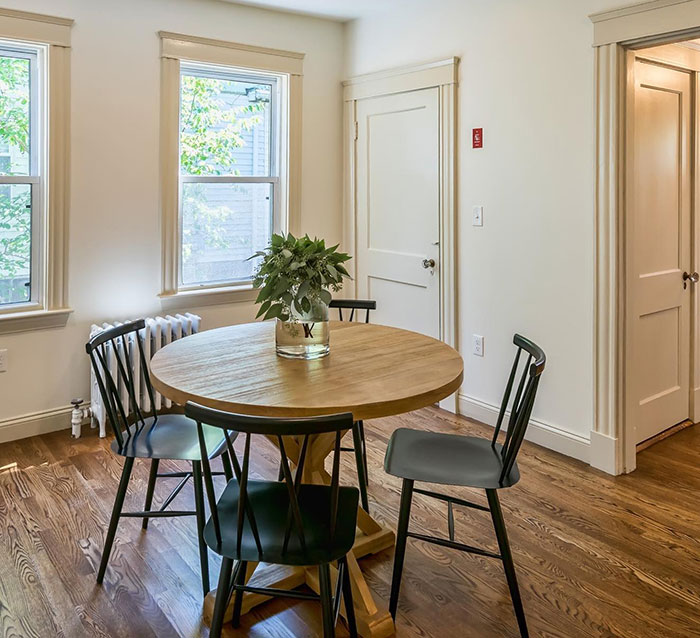 Round walnut table with Minwax stain colors in a bright white room surrounded by black chairs and natural light. Round walnut table with Minwax stain colors in a bright white room surrounded by black chairs and natural light.