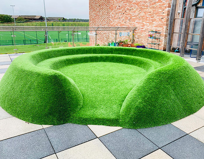 Artificial Grass Seating Looks Like It Was Photoshopped To The Scenery