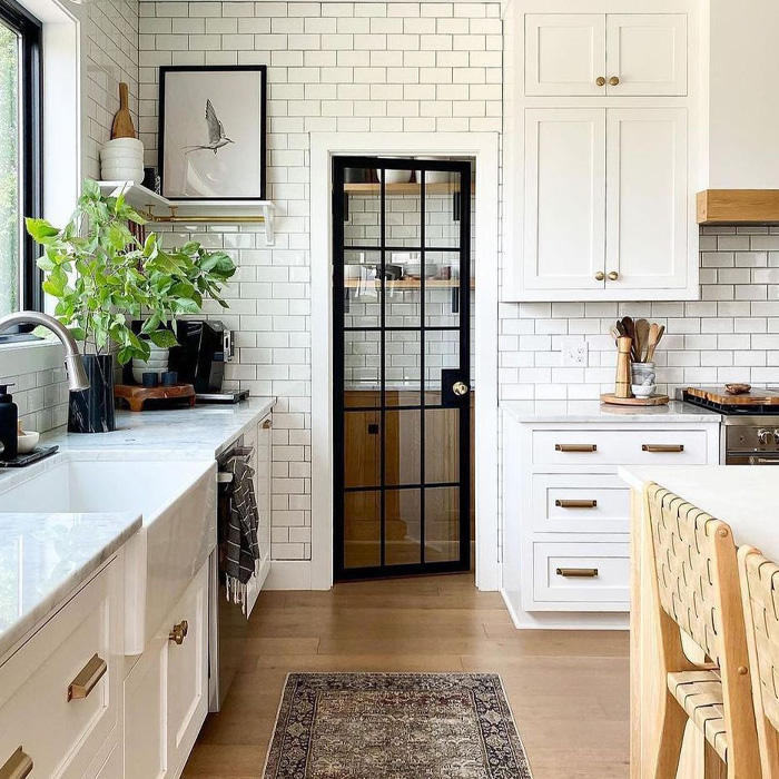 Glass pantry door in the white kitchen 