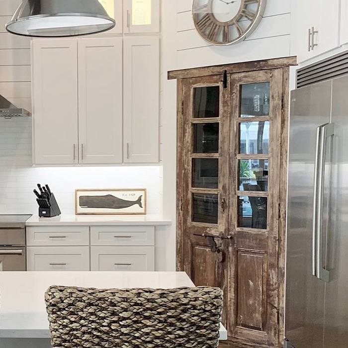 Kitchen with white kitchen cabinets and a pantry door in the corner Kitchen with white kitchen cabinets and a pantry door in the corner