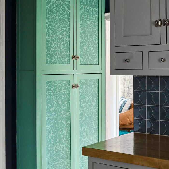 Green pantry with wallpaper door 