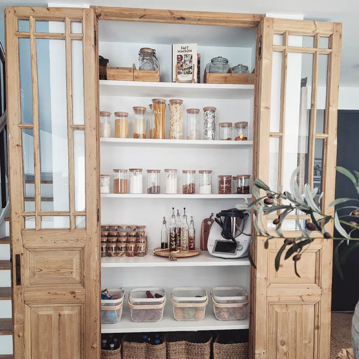 Pantry with opened wooden door Pantry with opened wooden door