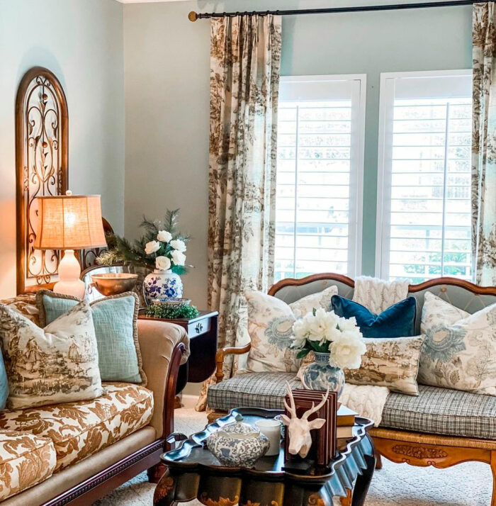Cozy living room featuring Sherwin-Williams paint colors with vintage lamp on table near patterned sofas and pillows. Cozy living room featuring Sherwin-Williams paint colors with vintage lamp on table near patterned sofas and pillows.