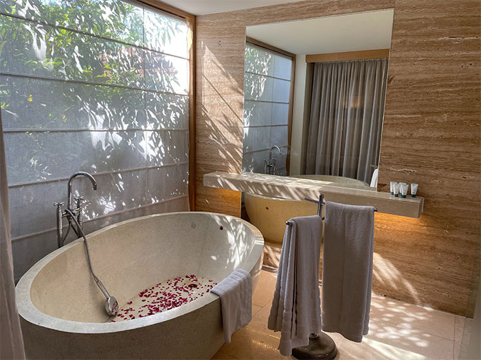 Minimalist style bathroom with stone soak tub Minimalist style bathroom with stone soak tub