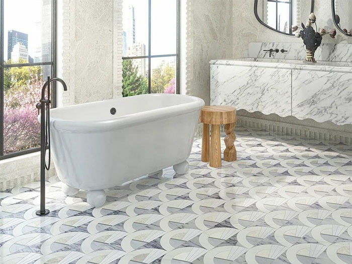 White bathroom with mosaic tiles and white soak tub