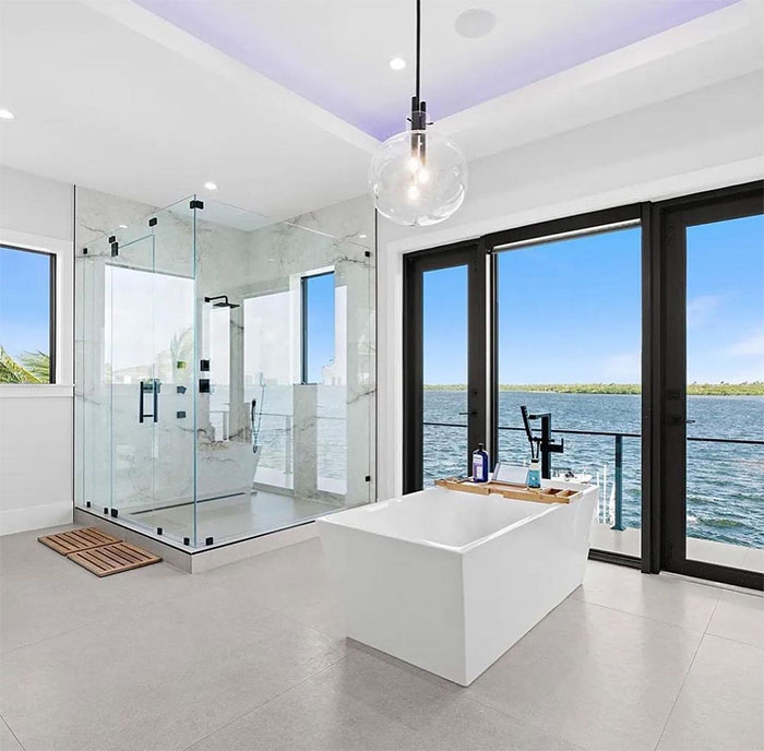 Bathroom with white decor and sea view Bathroom with white decor and sea view