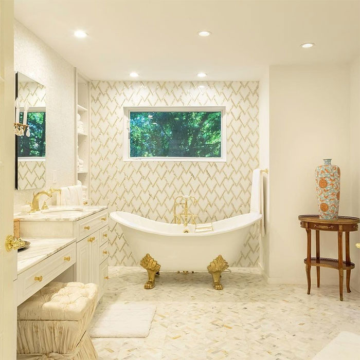 Bathroom with golden clawfoot tub